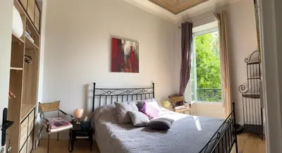 a bedroom with a bed and a window at Chambre Vue Jardin Alsace Lorraine Victor Hugo in Nice