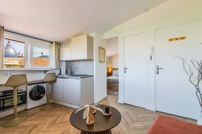 a kitchen and a living room with a table at 12, Boulevard Jean Jaures - Studio in Nice