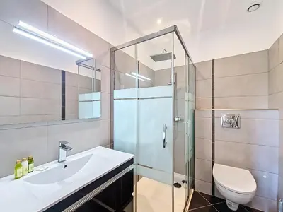 a bathroom with a shower and a sink and a toilet at Nestor&Jeeves - JEAN MEDECIN - Central - Modern in Nice