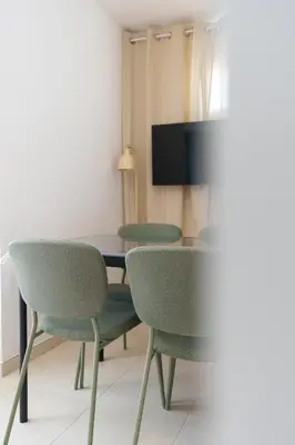 a dining room with two chairs and a table at Le Neoroch in Nice