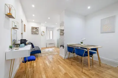 a kitchen and living room with a table and chairs at Nice Renting - 5 Massena - Elegant Air-Conditioned Cocoon Quiet Patio Massena in Nice