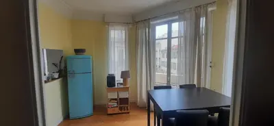 a dining room with a blue refrigerator and a table at Palais Clemenceau in Nice