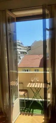 a view from a window of a balcony with a table at Palais Clemenceau in Nice