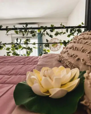 a flower sitting on top of a bed at AngeVert HolidayHouse in Nice