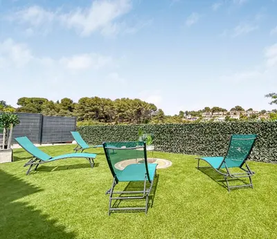 a group of chairs sitting on the grass at Havre de paix avec terrasse in La Gaude