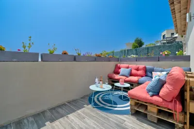 a patio with two chairs and a table at Maison niçoise vue dégagée avec jacuzzi privatif in Nice