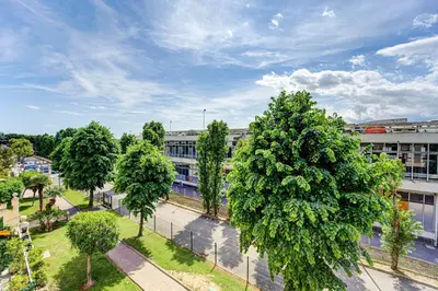 an overhead view of a building with trees in front at Sandaya - 10min à pied de la Plage in Cagnes-sur-Mer