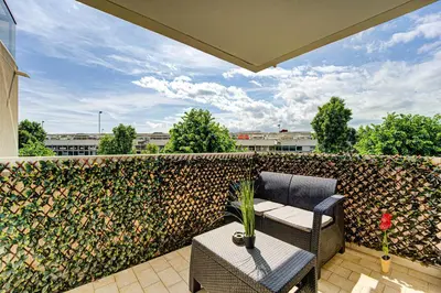 a patio with a table and chairs and a fence at Sandaya - 10min à pied de la Plage in Cagnes-sur-Mer