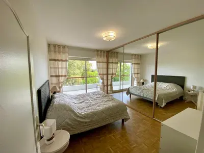 a bedroom with two beds and a mirror at Nice West Pretty one bedroom in Nice