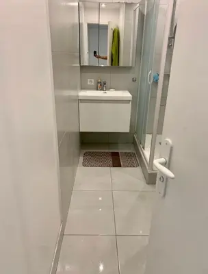 a white bathroom with a sink and a shower at Big Apartement 20 min from beach in Nice
