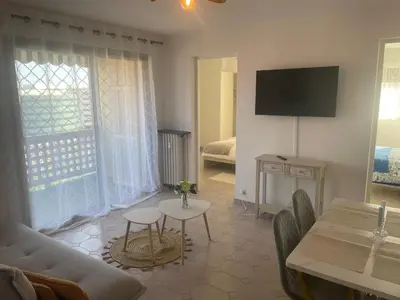 a living room with a couch and a table at Sun appart in Nice