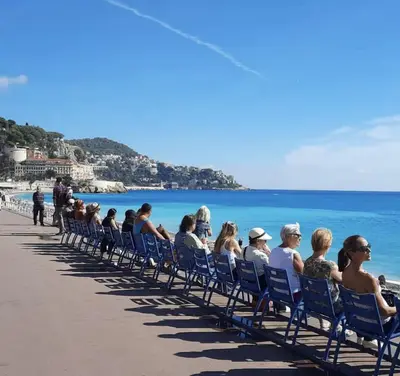 a group of people sitting in chairs on a beach at Spacieux et Moderne T2 - Hyper Centre in Nice
