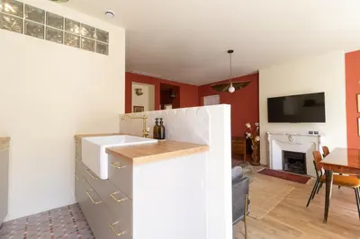 a kitchen and living room with a fireplace at Le charme de l'ancien, rénové - Nice - 4 personnes in Nice