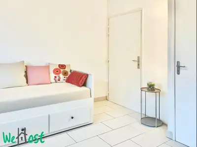 a living room with a couch and a table at WeHost Carnot - Bail Mobilité ONLY - Escapade côté Port pour 2 in Nice