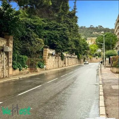 a view of the amalfi coast with palm trees and buildings at WeHost Carnot - Bail Mobilité ONLY - Escapade côté Port pour 2 in Nice