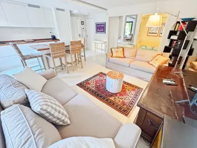 a living room with a couch and a table at Green Heaven Apt, Rickeys in Cap d'Ail