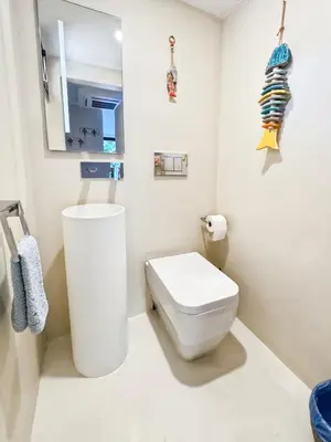 a white bathroom with a toilet and a mirror at Green Heaven Apt, Rickeys in Cap d'Ail