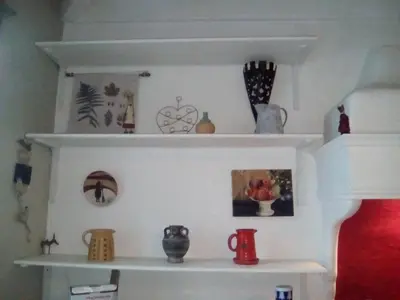 a shelf with vases and other items on it at Maison authentique in Nice