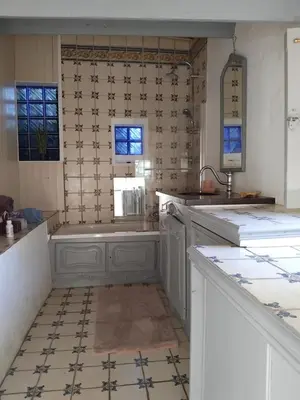 a kitchen with a tub and a tile floor at Maison authentique in Nice