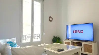 a living room with a tv and a couch at La Baieta - Typical Nice Apartment in Nice