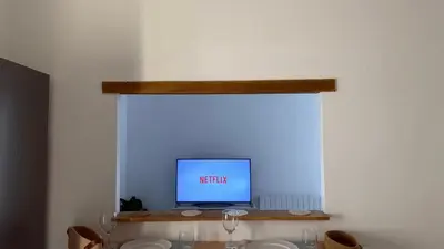 a television sitting on a shelf in a window at La Baieta - Typical Nice Apartment in Nice