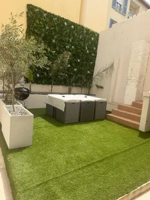 a small garden with a bed of green grass at Appartement Duplex Bord de Mer in Cagnes-sur-Mer
