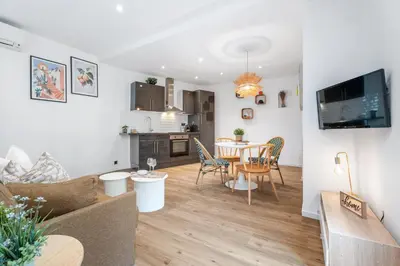 a living room and kitchen with a table and chairs at Nice Renting - 35 Massena - Architect Flat Ultimate Charm Massena Center in Nice