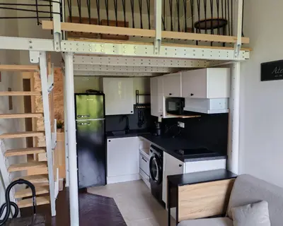 a loft bed in a kitchen with a stove top oven at Cosy Mezzanine Studio - Nice Notre Dame - 10 min Promenade in Nice