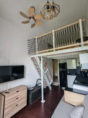 a living room with a spiral staircase in the ceiling at Cosy Mezzanine Studio - Nice Notre Dame - 10 min Promenade in Nice