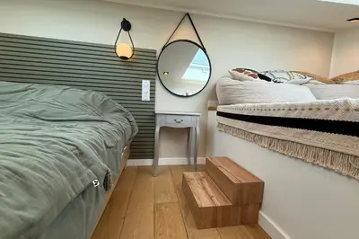 a bedroom with two beds and a mirror on the wall at Nice studio in the heart of Old Nice - 4 pers in Nice