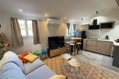 a living room with a couch and a kitchen at Nice studio in the heart of Old Nice - 4 pers in Nice