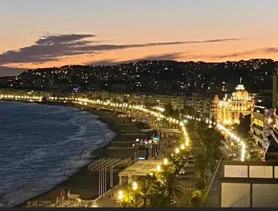 a view of a beach at night with street lights at Hyper Center - Superb Studio - Cozy - Wifi in Nice