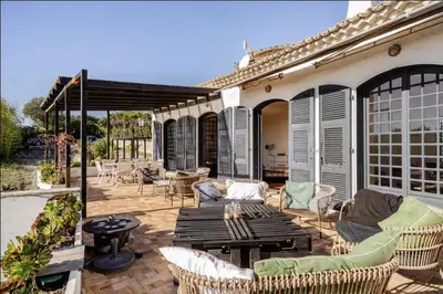a patio with a table and chairs on a patio at Séjour de luxe sur les collines niçoises in Nice
