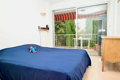 a bedroom with a blue bed with a teddy bear on it at Beautiful 3-room apartment with terrace in Nice
