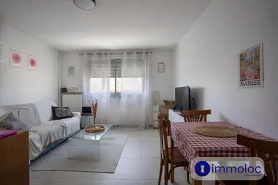 a kitchen and dining room with a table and a television at Studio near airport in Nice