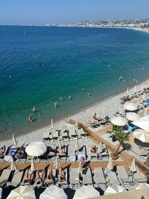an overhead view of a beach with chairs and umbrellas at Superbe 2 pièces contemporain au cœur de Nice in Nice