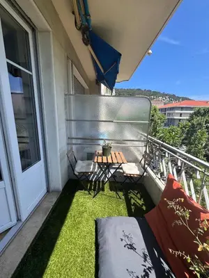 a small balcony with a table and chairs on it at Beautiful 2-room, AC, Center, terrace in Nice