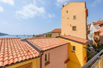 a view of roofs of buildings in a city at BAY VIEW AP4470 By Riviera Holiday Homes in Villefranche-sur-Mer