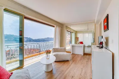 a living room with a view of the water at Dina palace AP4462 By Riviera Holiday Homes in Villefranche-sur-Mer