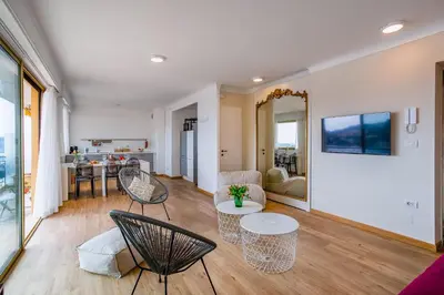 a living room with two chairs and a table at Dina palace AP4462 By Riviera Holiday Homes in Villefranche-sur-Mer