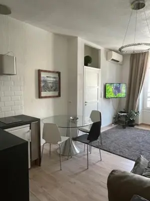 a living room with a glass table and chairs at Apartment on Dante street next to the sea in Nice