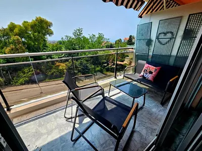 two chairs and a table on a balcony at T2 Vue Mer avec Grande Terrasse & Parking 4 min Plage - SpiritofFamily06 in Cagnes-sur-Mer