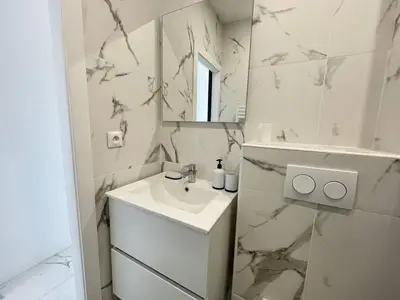 a white bathroom with a sink and a mirror at Nice Signature Andrioli in Nice