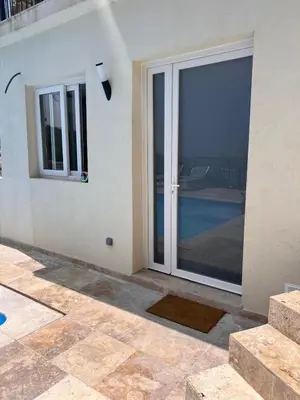 a sliding glass door of a house with a balcony at Amoremio studio Saint Laurent du Var in Saint-Laurent-du-Var