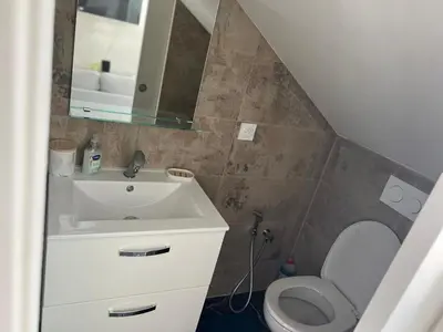 a bathroom with a sink and a toilet and a mirror at Amoremio studio Saint Laurent du Var in Saint-Laurent-du-Var