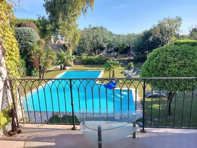 a balcony with a view of a swimming pool at Villa, Villefranche-sur-mer, Pool, Tennis Court, in Villefranche-sur-Mer