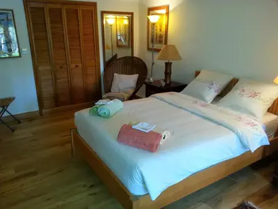 a bedroom with a large bed with a purse on it at Villa, Villefranche-sur-mer, Pool, Tennis Court, in Villefranche-sur-Mer