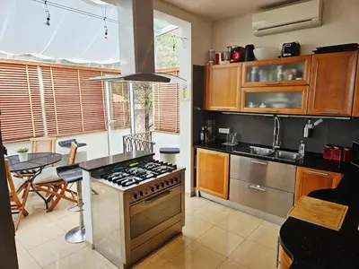 a kitchen with a stove and a table in it at Villa, Villefranche-sur-mer, Pool, Tennis Court, in Villefranche-sur-Mer