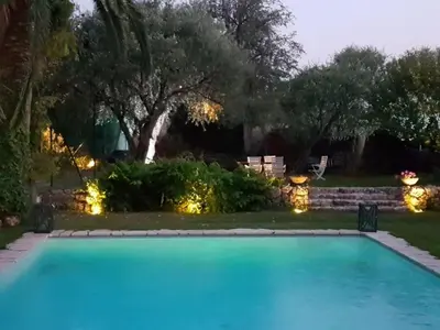 a pool with lights in a yard at night at Villa, Villefranche-sur-mer, Pool, Tennis Court, in Villefranche-sur-Mer
