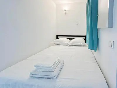 a bed with white sheets and towels on it at Élégance Azuréenne - piscine et parking in Villefranche-sur-Mer
